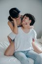 Man in White Crew Neck T-shirt Kissing Womans Cheek