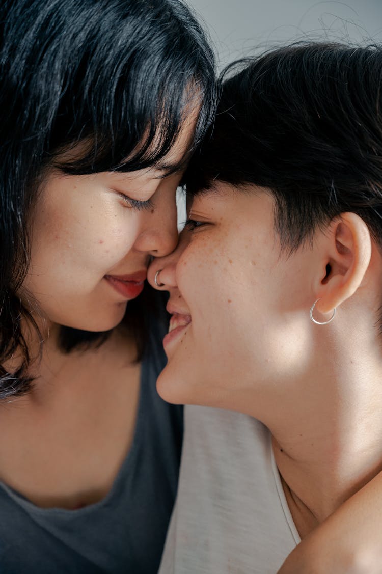 Portrait Of Women Affectionately Touching Noses