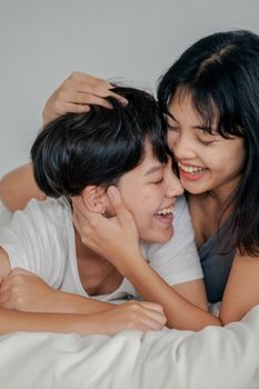 快乐的夫妇在床上拥抱大笑，分享着亲密的时刻