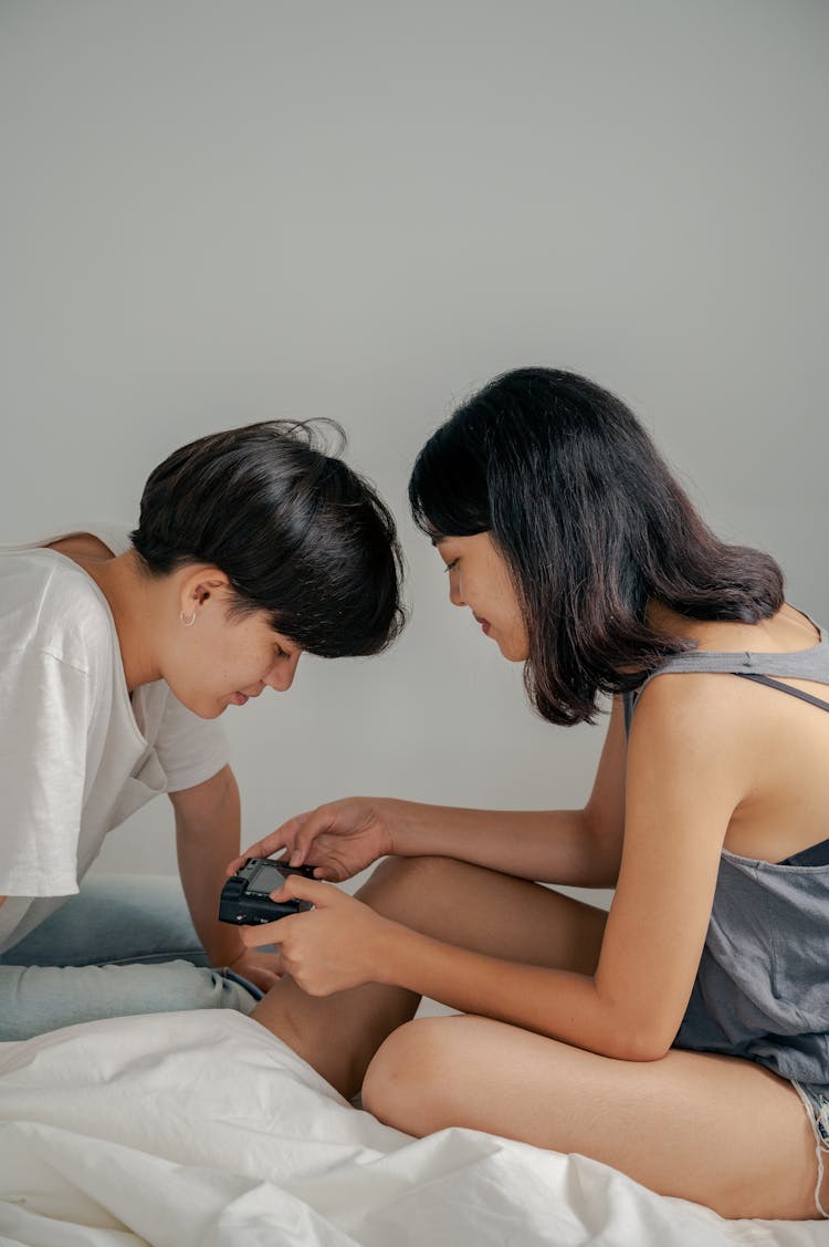 
A Couple Looking At A Camera 