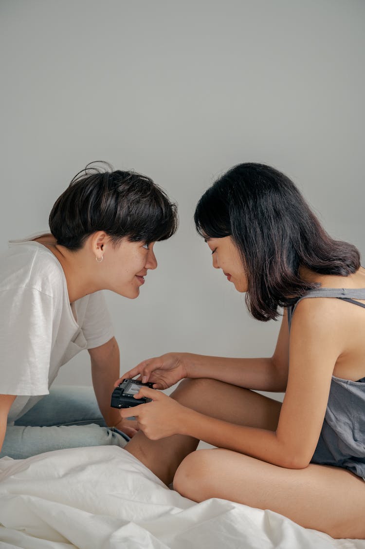 A Couple Looking At A Camera 