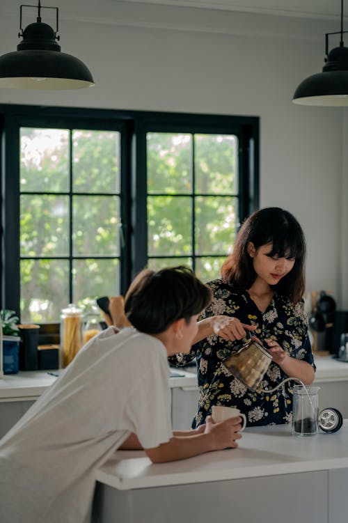 Free Women Making Morning Coffee in Kitchen Stock Photo