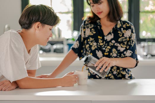 Two women share a peaceful morning moment with coffee indoors.