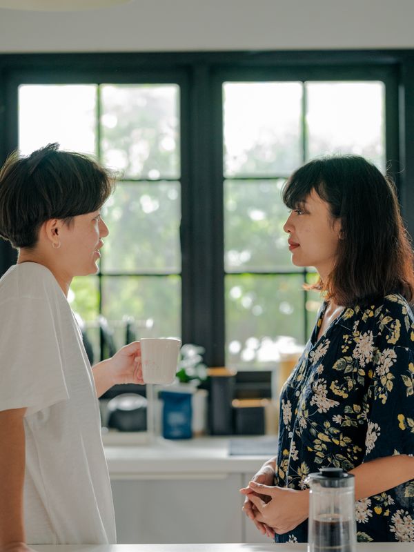 A couple talking over coffee in a bright kitchen — photo by Ketut Subiyanto on Pexels
