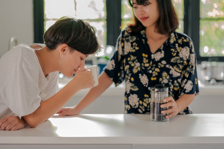 Couple Drinking Coffee In Kitchen 