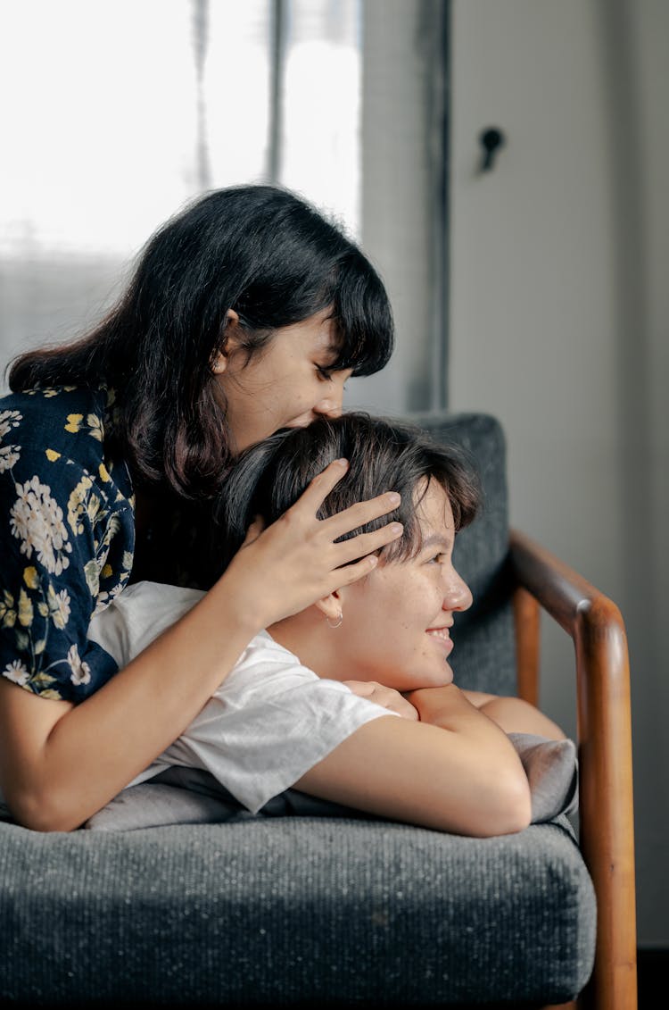 Photo Of Couple Having Fun While Lying On Couch