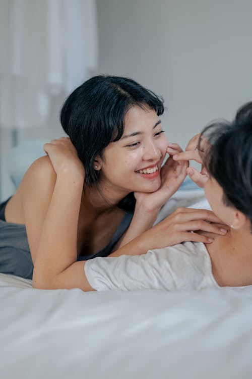 Free  Photo of Woman Lying on Bed With Her Man Stock Photo