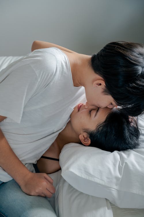Free Photo of Man Kissing Her Woman on Her Forehead Stock Photo