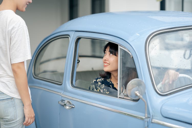 Woman In Vintage Car Staring At Woman Passing By