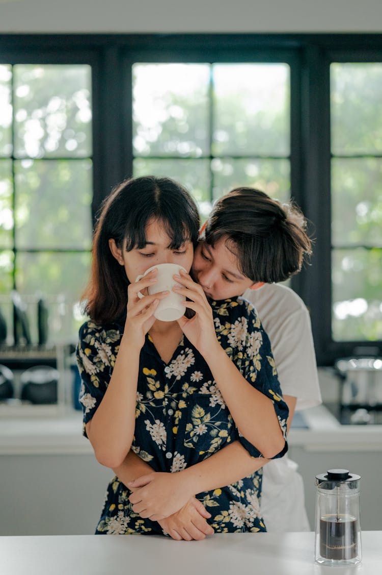 Couple Embracing And Having Coffee 