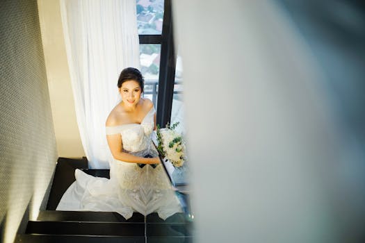 Radiant bride holding bouquet, ascending stairs in elegant dress, exuding happiness and grace.
