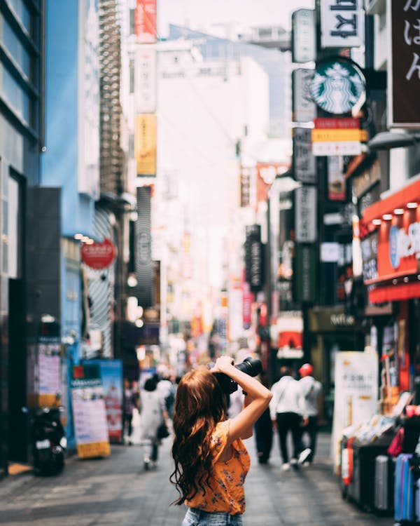 Free Photo of Woman Taking Pictures Using Black Camera Stock Photo