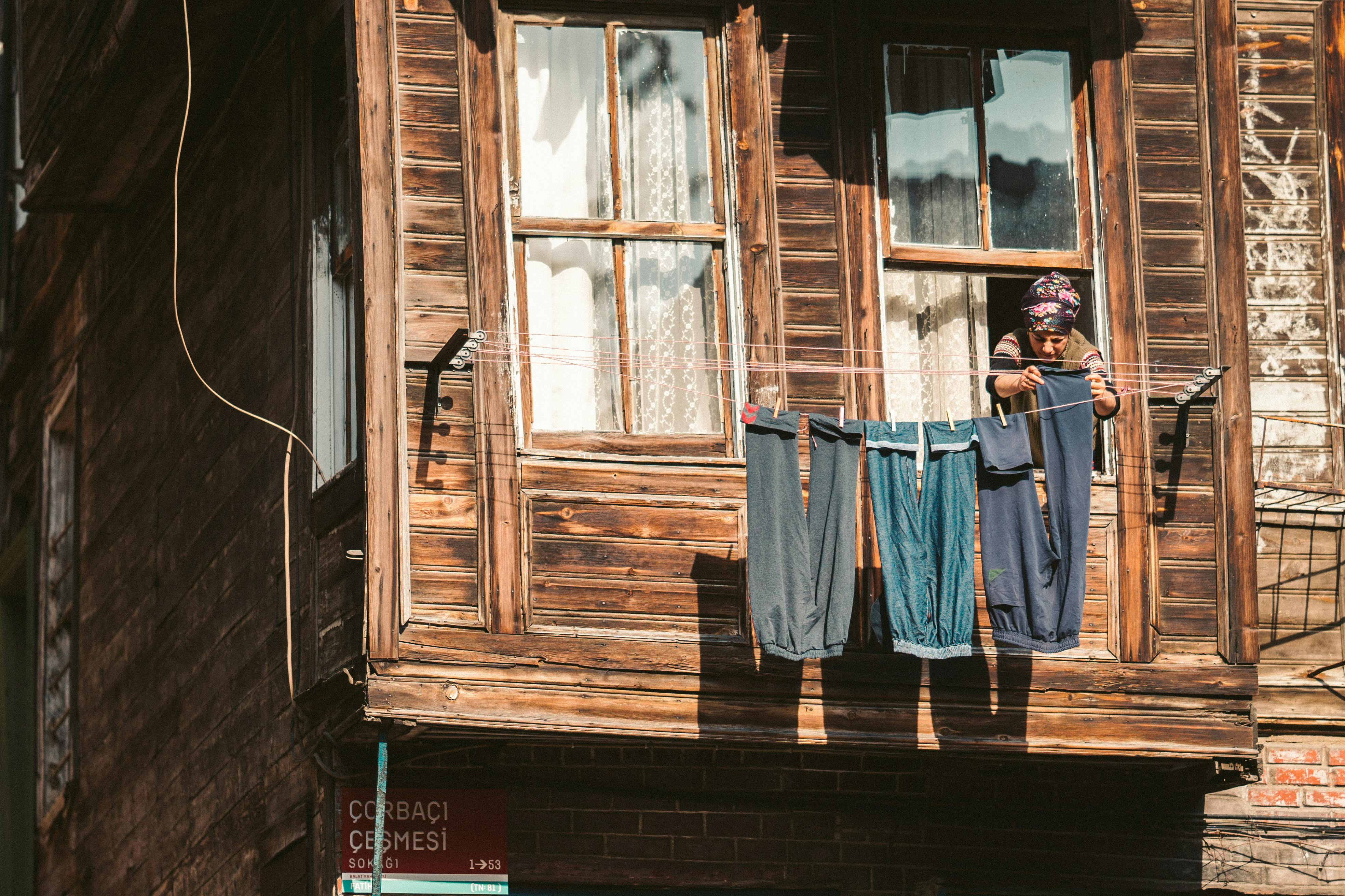 A Woman Hanging Pants on the Clothesline