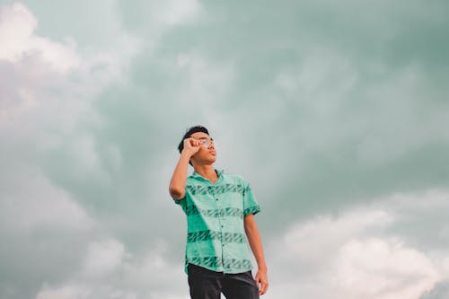 Free Man Adjusting his Eyeglasses Stock Photo