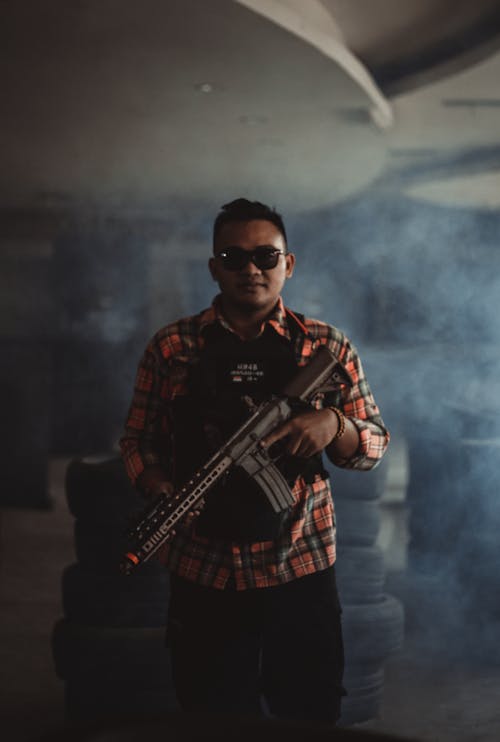 Free Photo of Man Holding Black Rifle Stock Photo