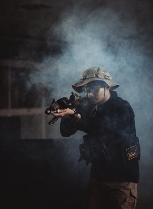 Photo of Man Holding Black Rifle
