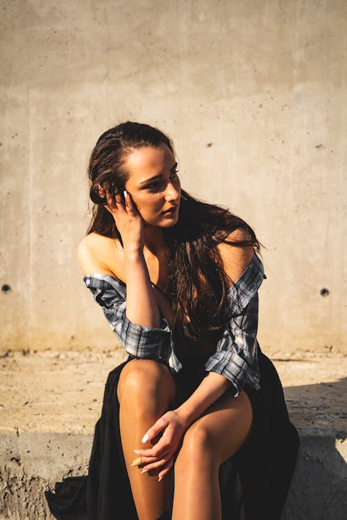Free A Woman Sitting on the Concrete Bench Stock Photo
