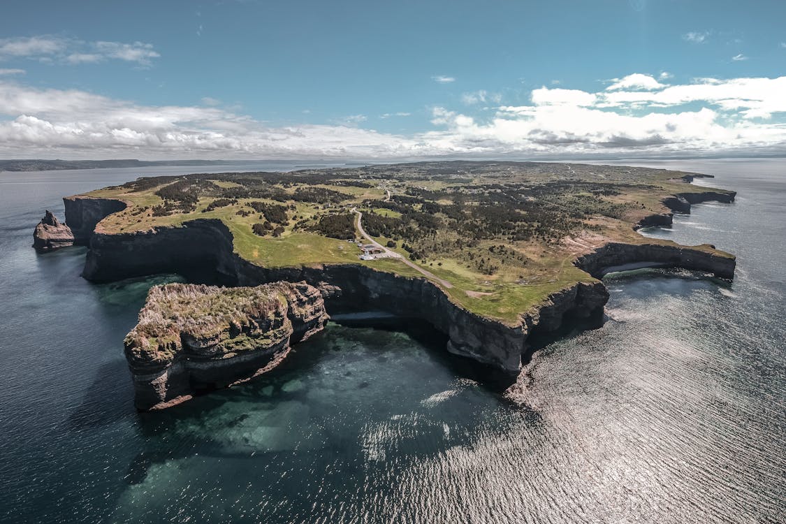 Aerial View of Island Surrounded by Body of Water