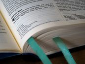 Close-Up Photo of Book Page With Green Book Mark