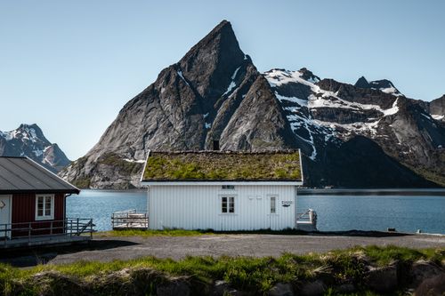 Free Charming village houses with stunning mountain and fjord backdrop in Nordland, Norway. Stock Photo