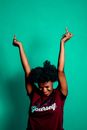 Cheerful black woman showing fuck gesture