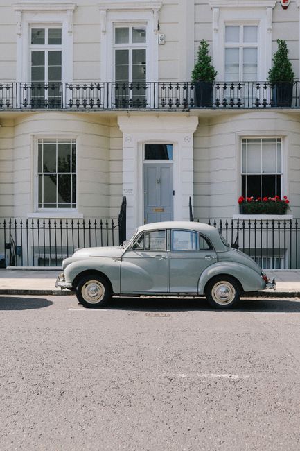 Charming vintage car in front of a classic London townhouse, showcasing elegant architecture.