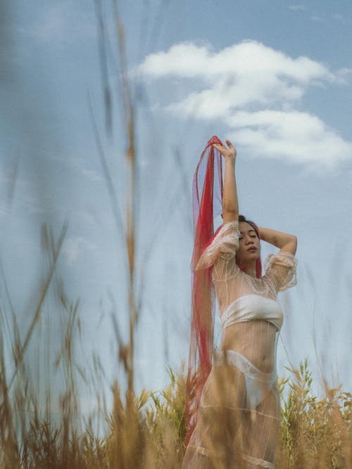 Woman Wearing Lace Dress Standing on Grass Field