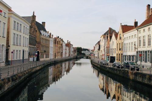 Free Beautiful canal lined with historic buildings in a European city, reflecting calm waters. Stock Photo