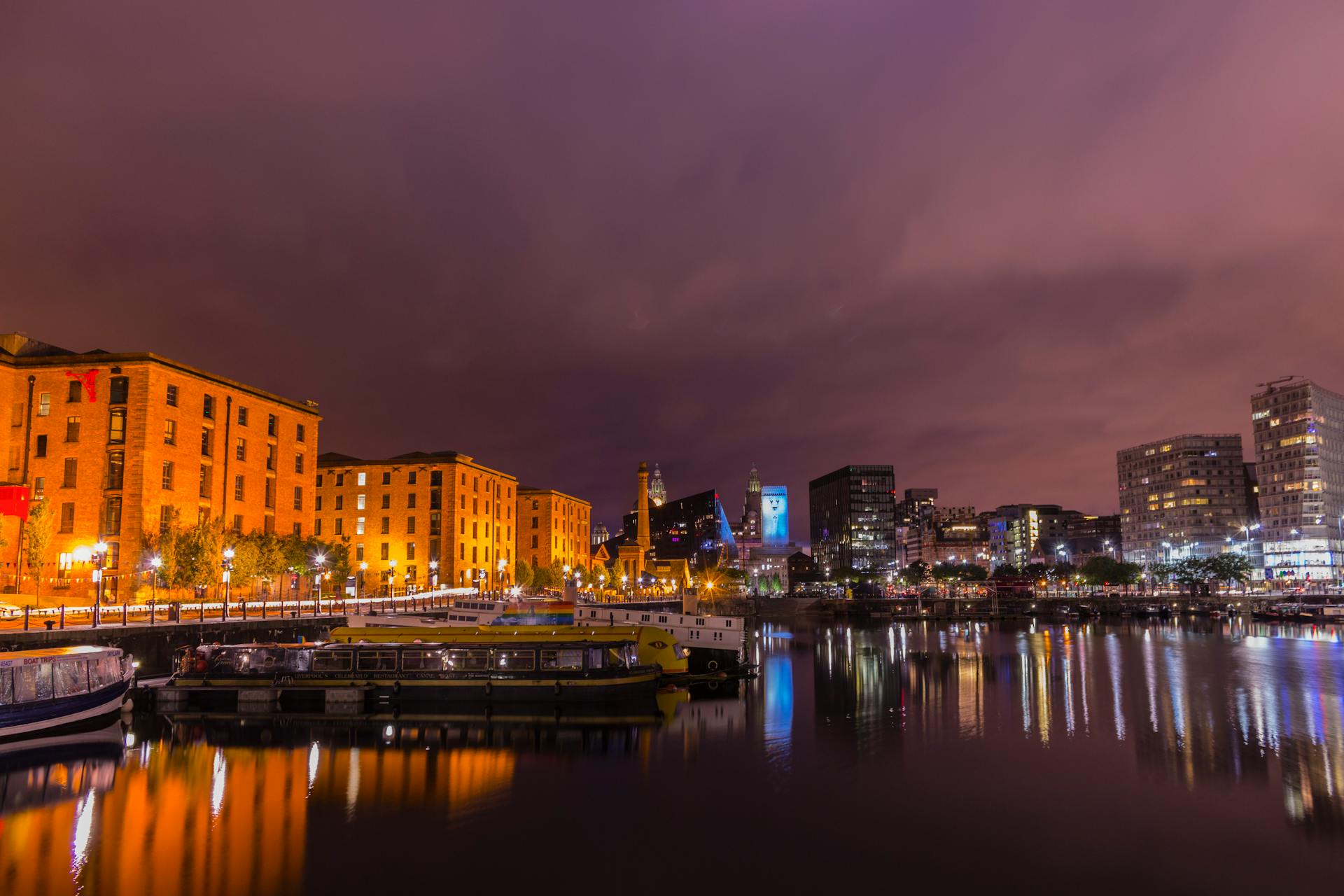 Stunning view of Liverpool's Albert Dock with cityscape reflections at dusk.