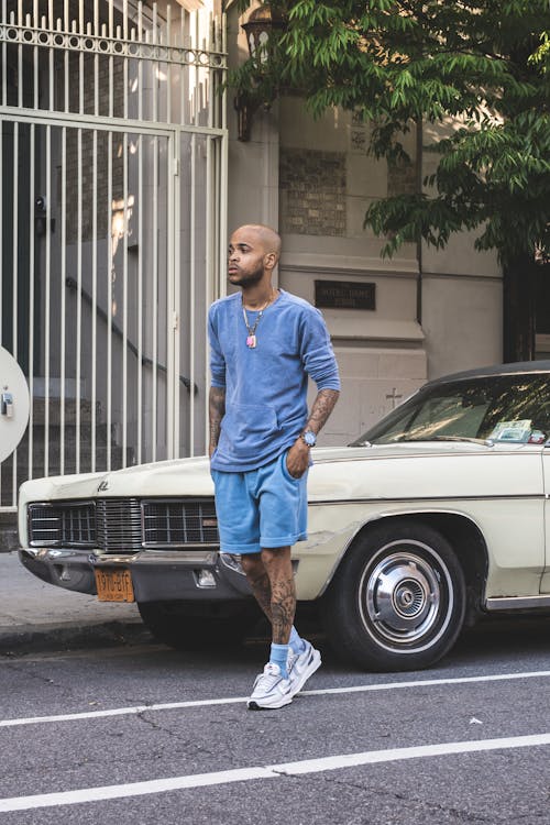 Man Wearing Blue Long Sleeve Shirt Waking on the Street