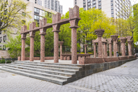Brown Concrete Monument Near the Green Trees