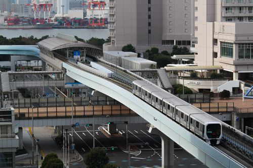 Free Stunning aerial view of Tokyo monorail passing through a modern urban landscape with city buildings. Stock Photo