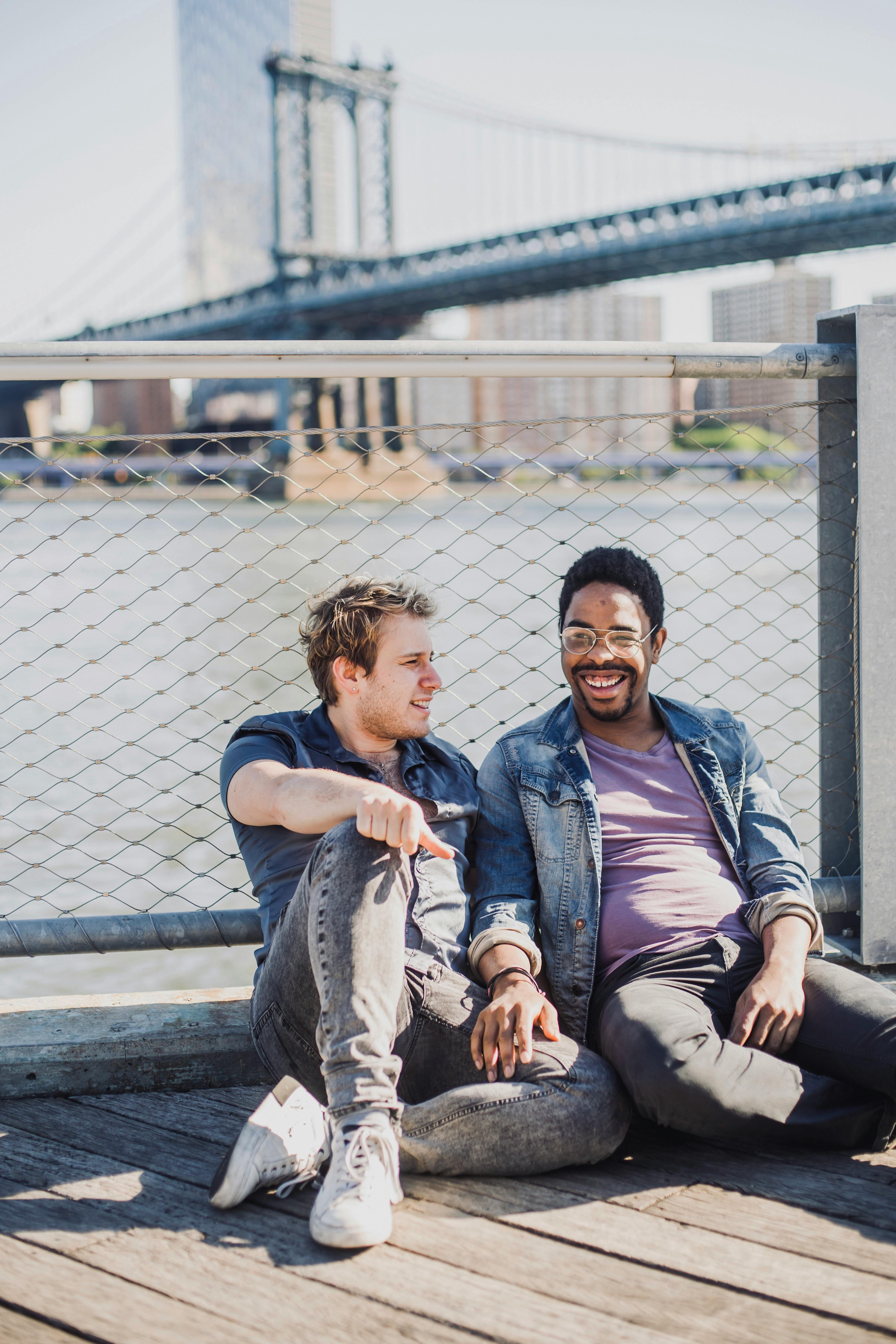 two men smiling and sitting on the floor