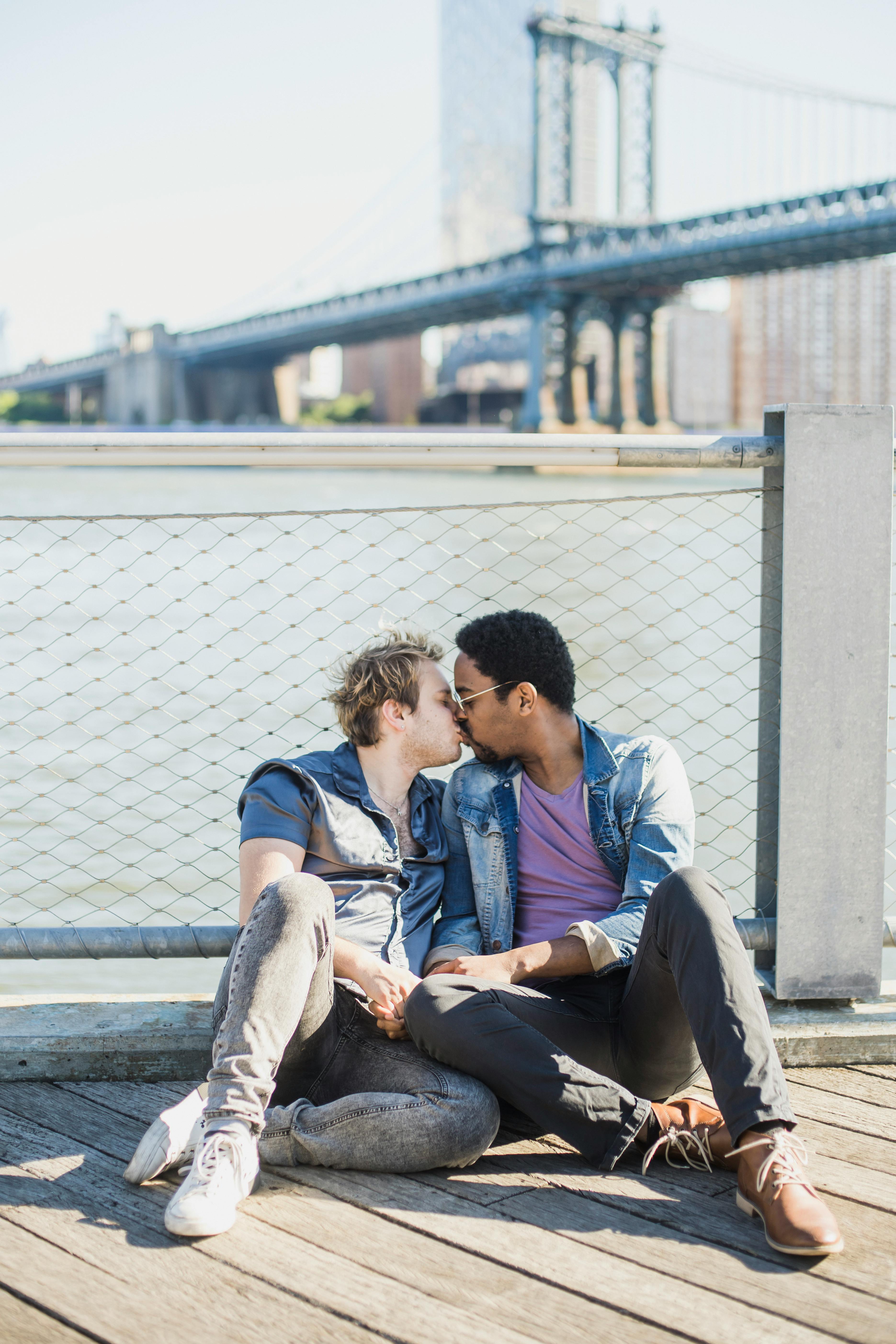 men sitting on the floor and kissing