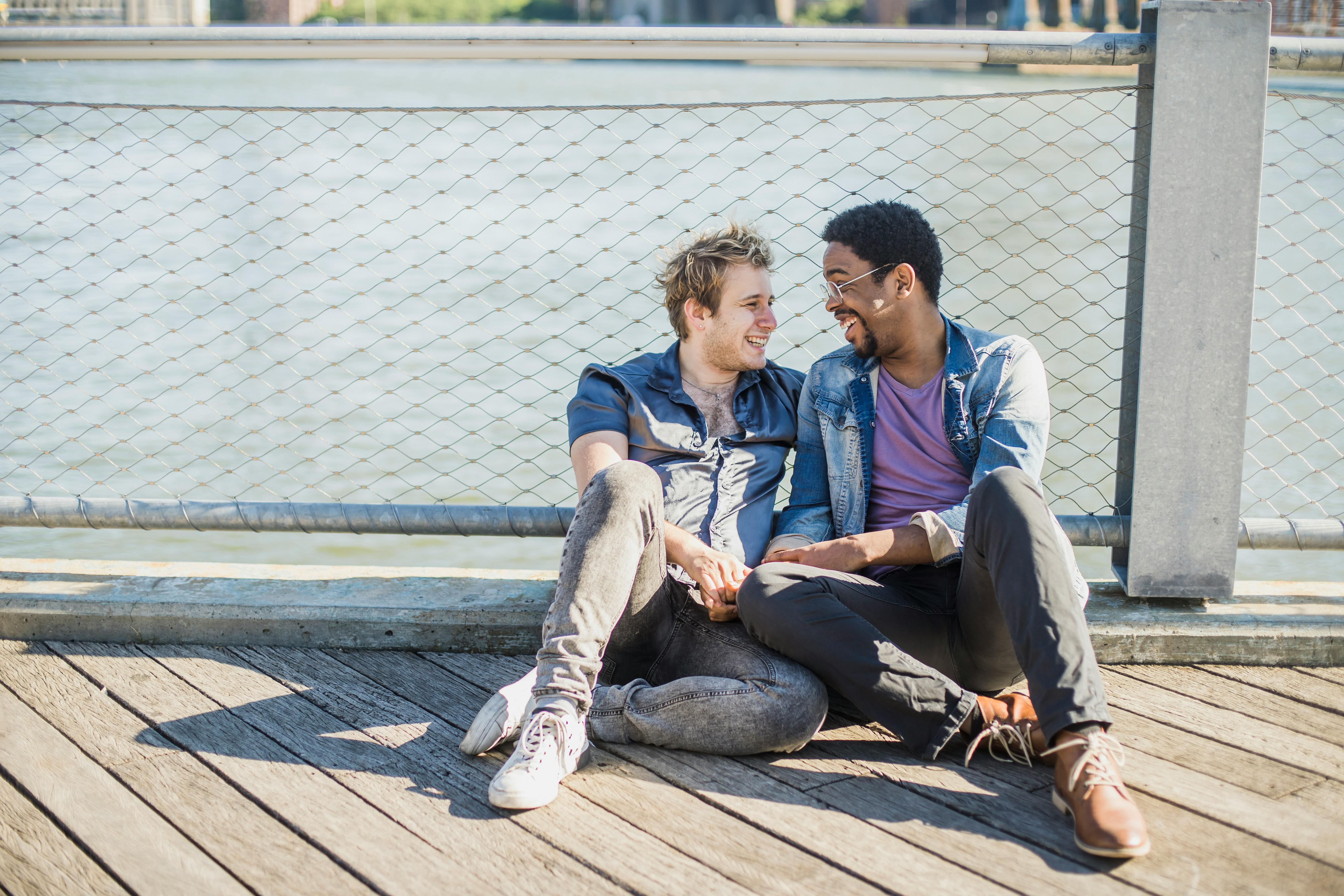 men sitting on the floor and holding hands