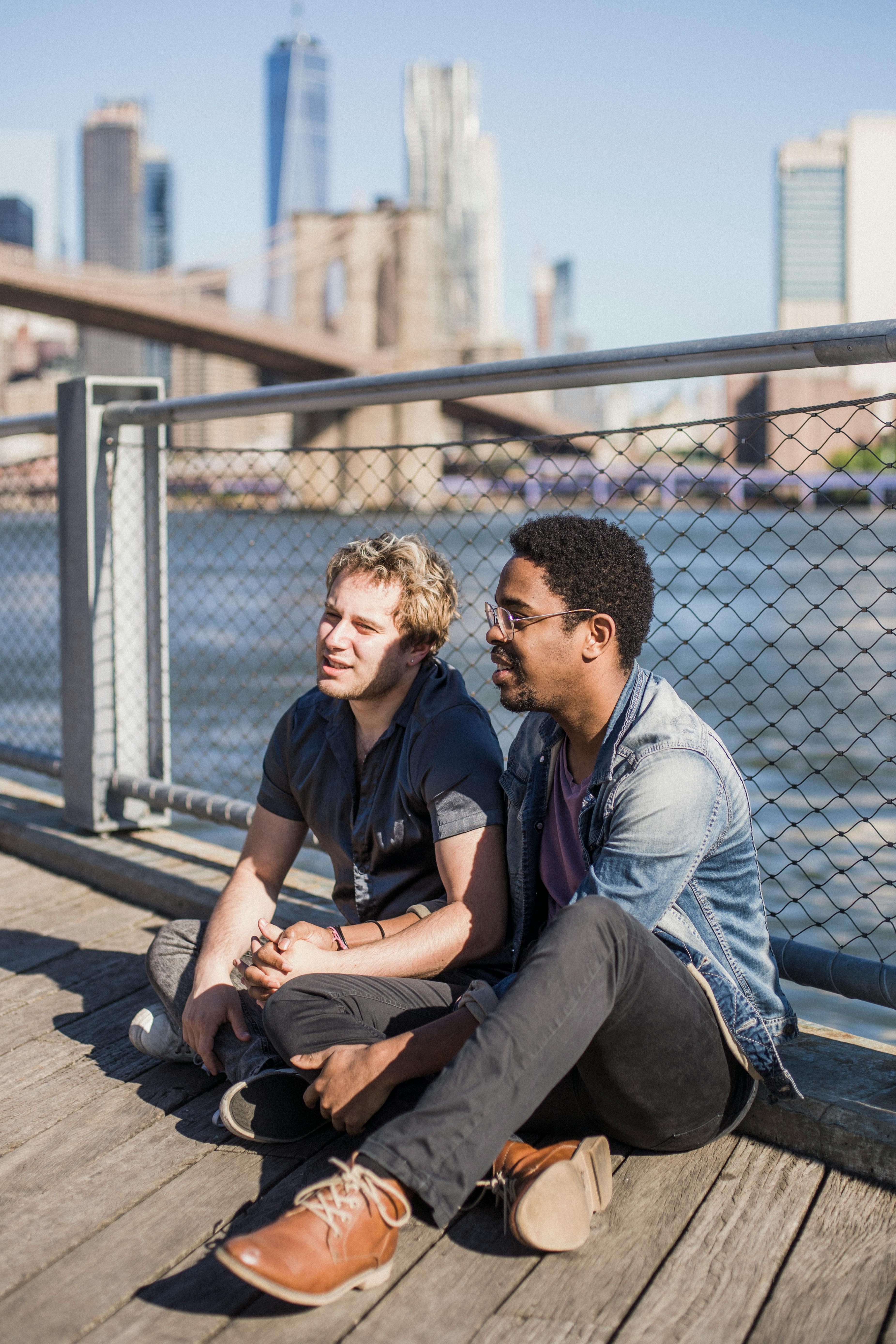 men sitting on the floor and holding hands