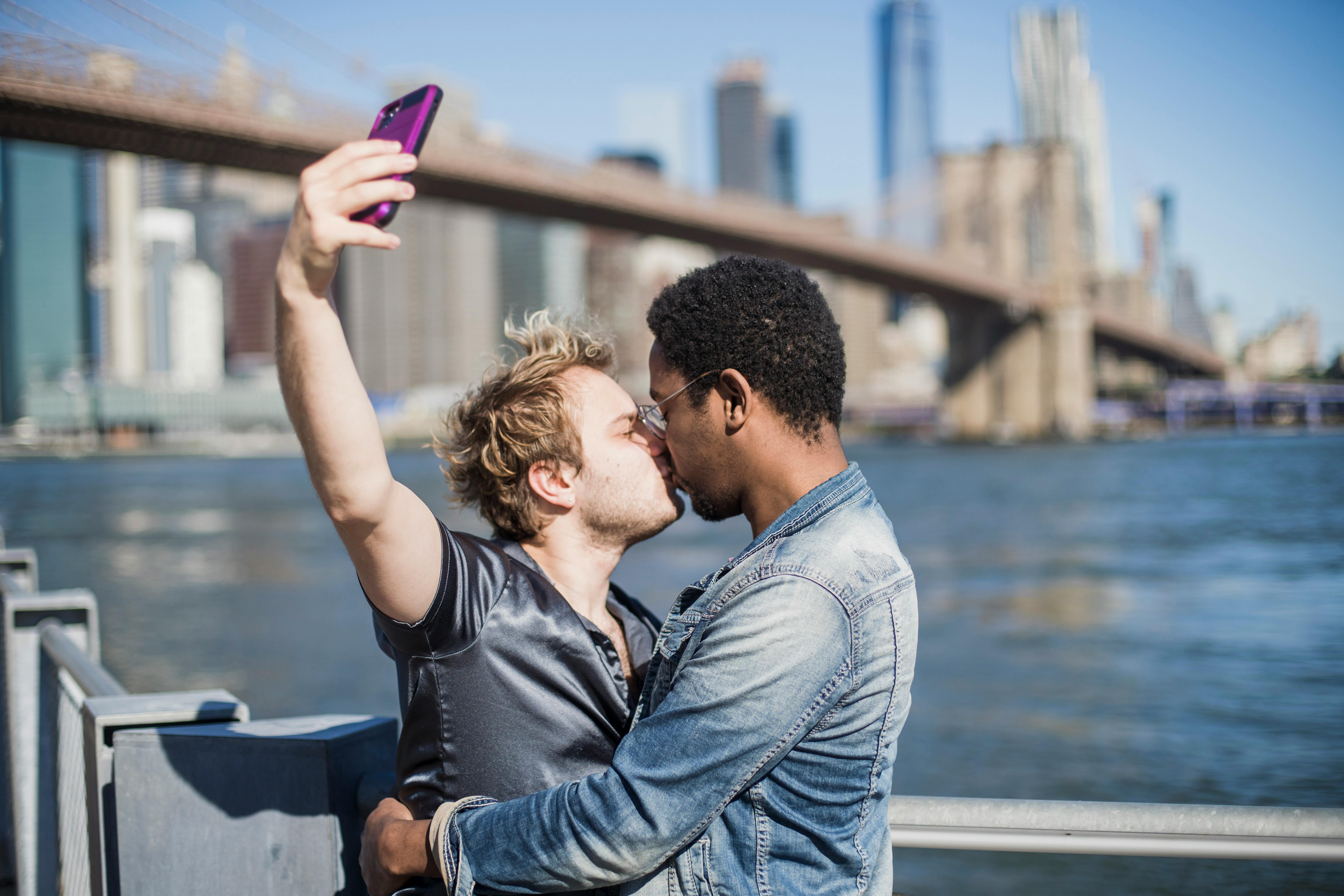 couple kissing and taking a selfie