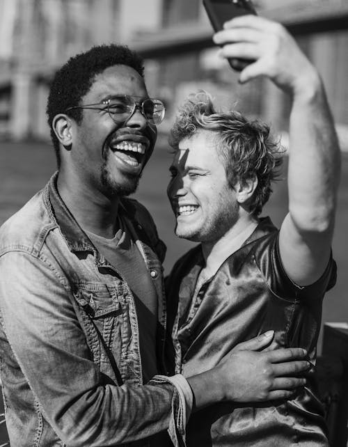 Grayscale Photo of Two Men Taking a Selfie