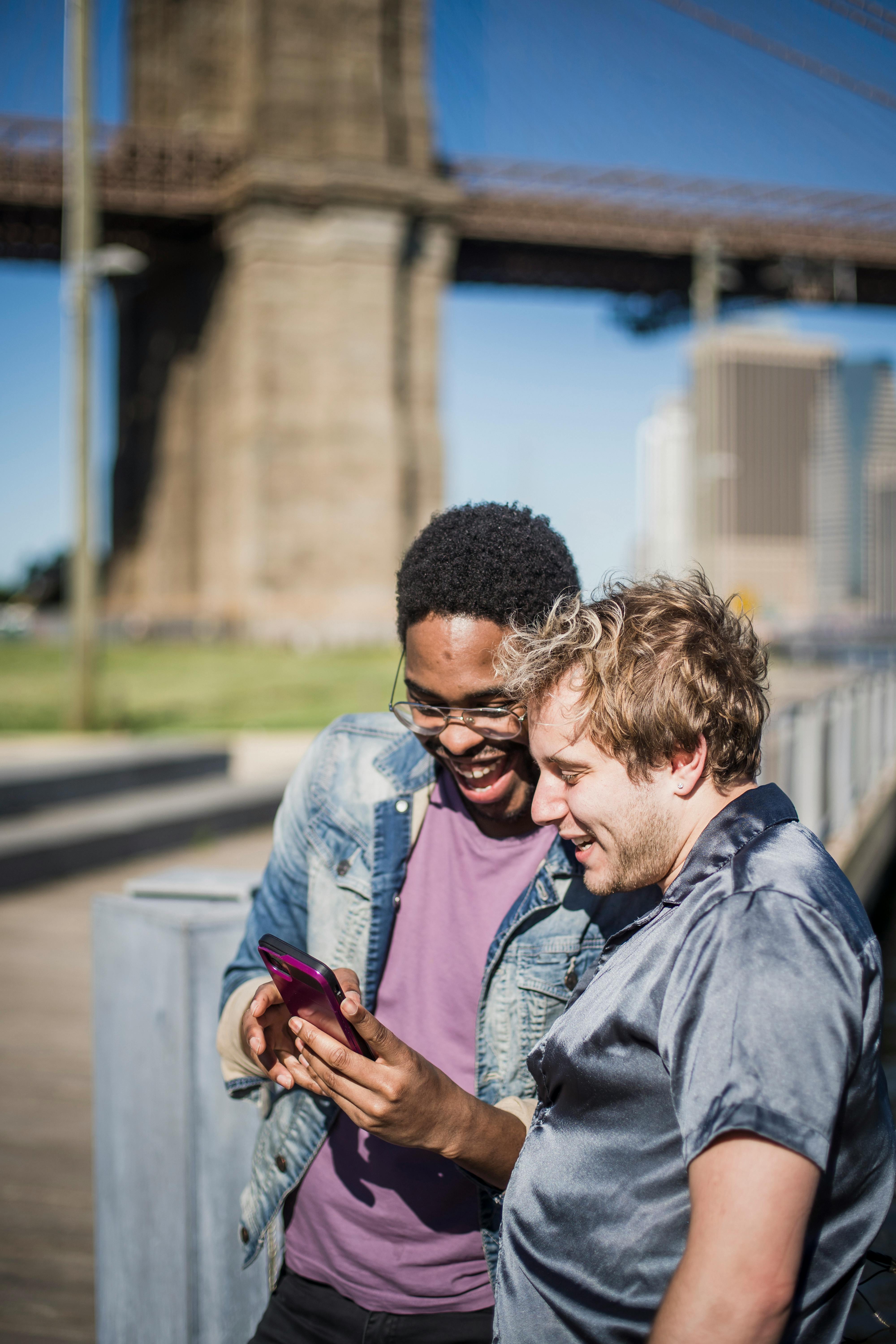 two men looking at smart phone and laughing