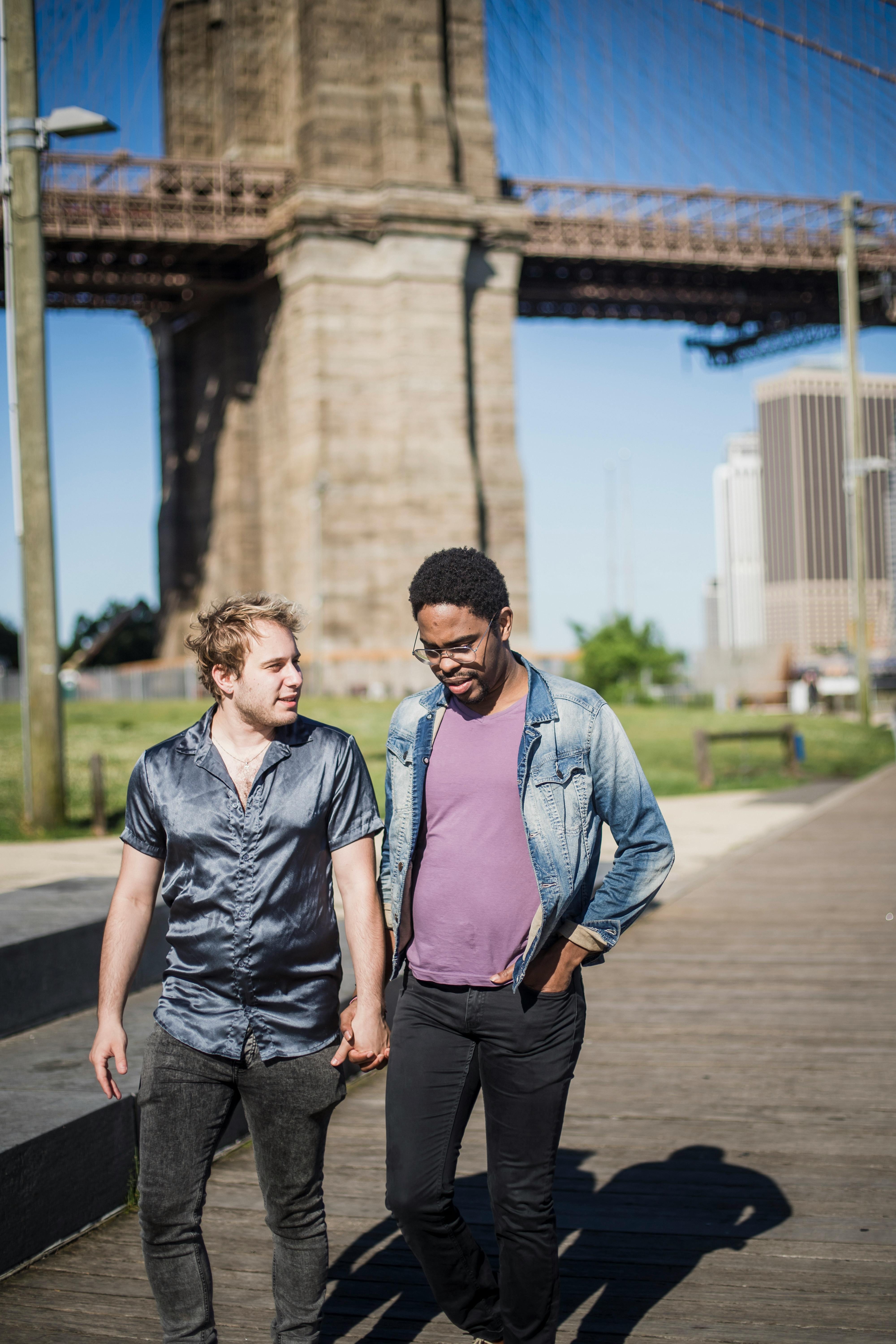 two men walking and holding hands