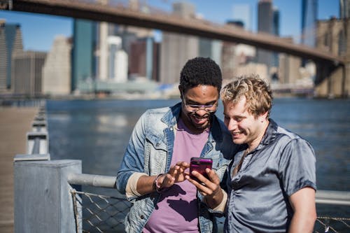 Free Two Men Looking at a Smartphone Stock Photo