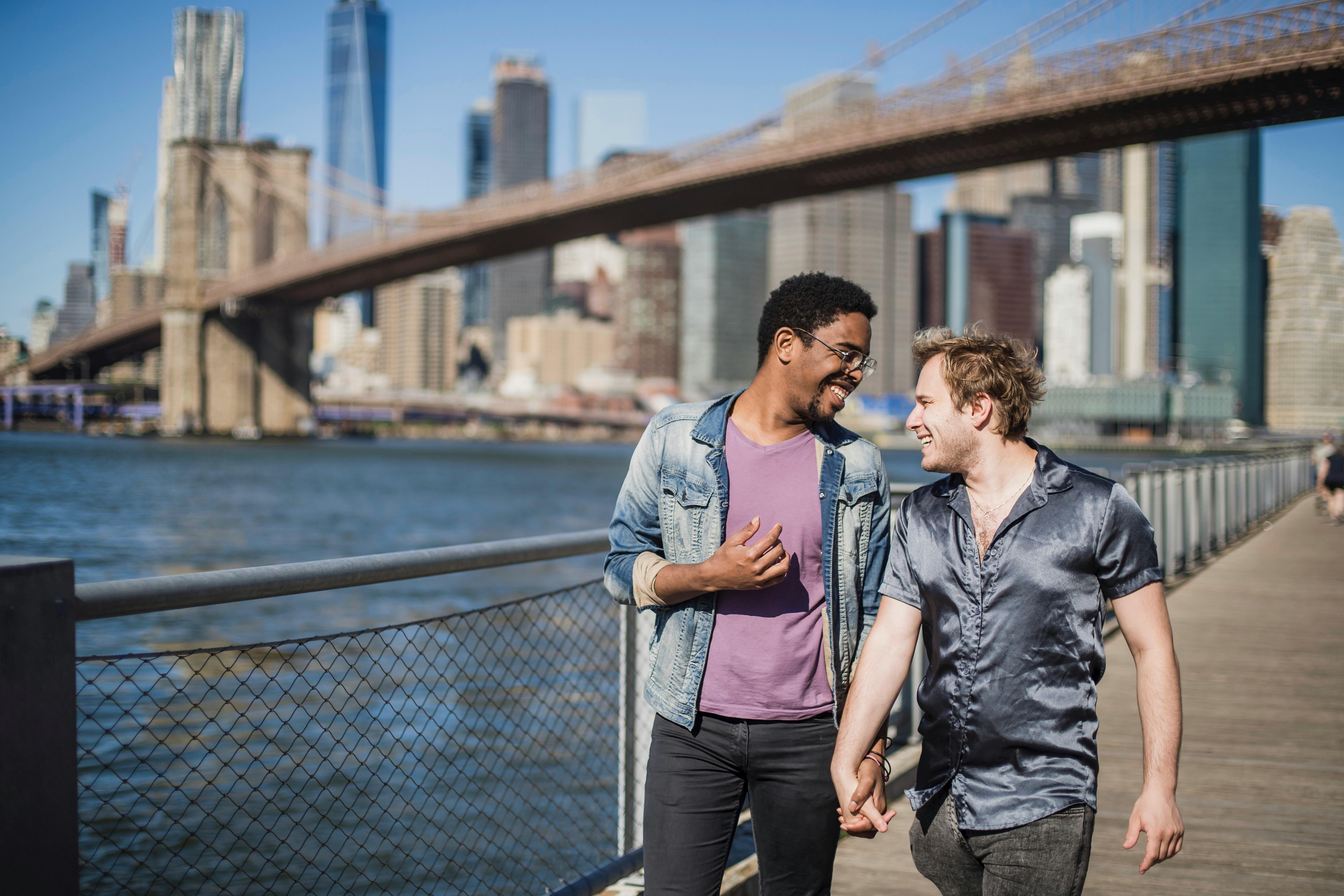 two men walking and holding hands