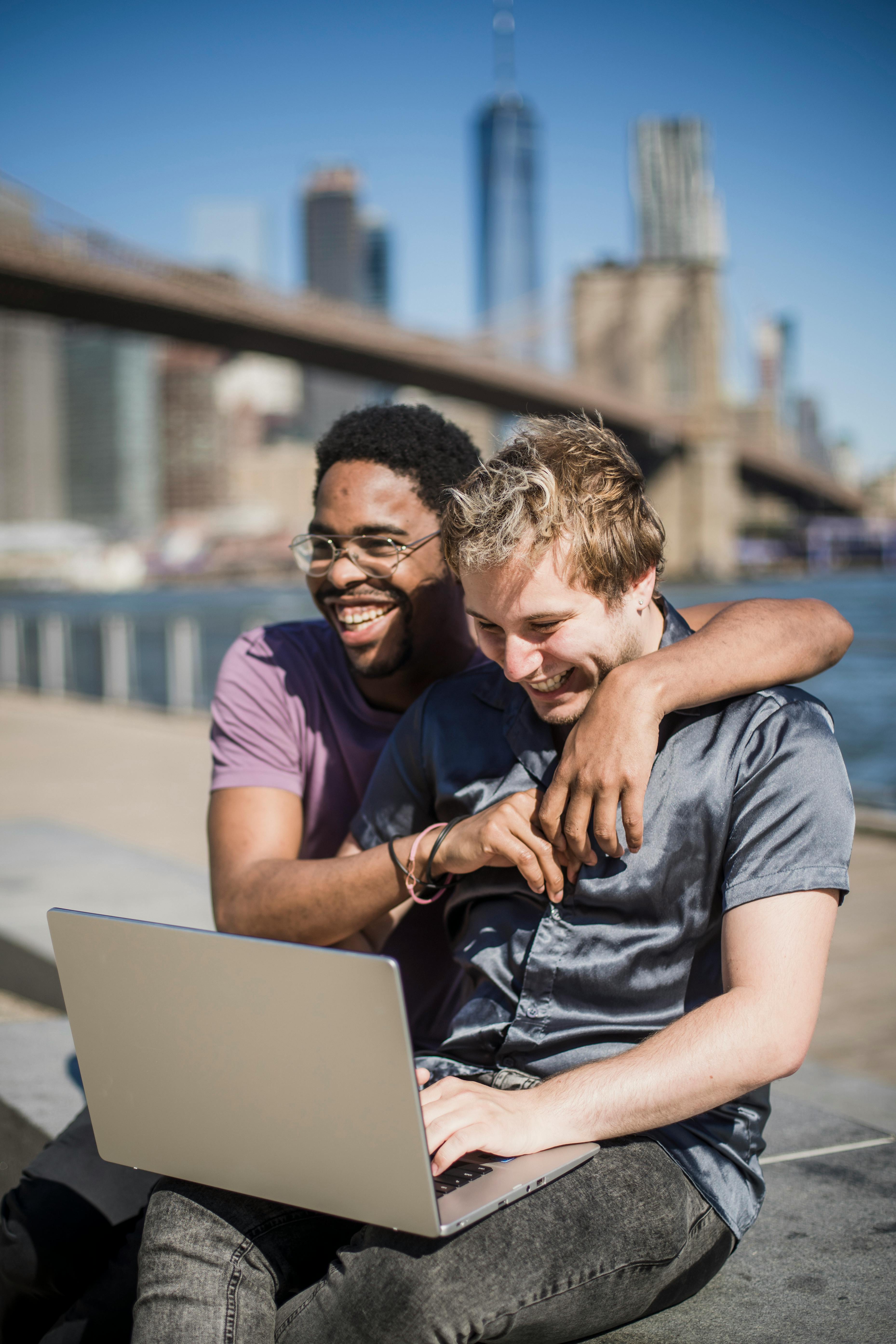 men outside with a laptop