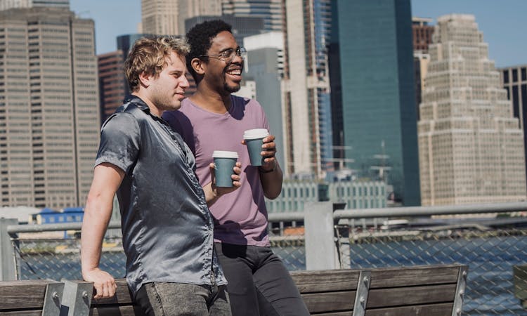 Happy Men Holding Paper Cups