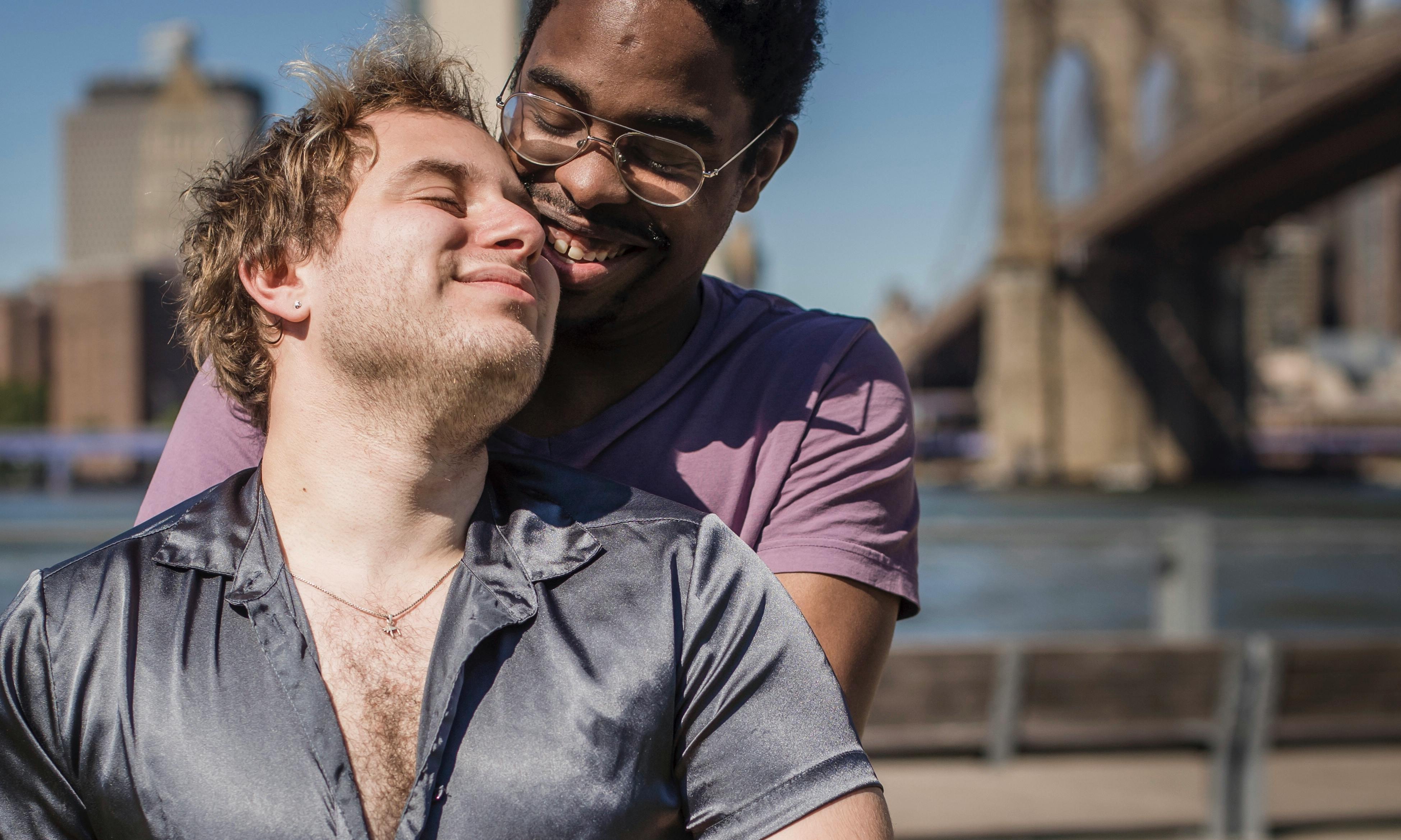 two happy men being affectionate