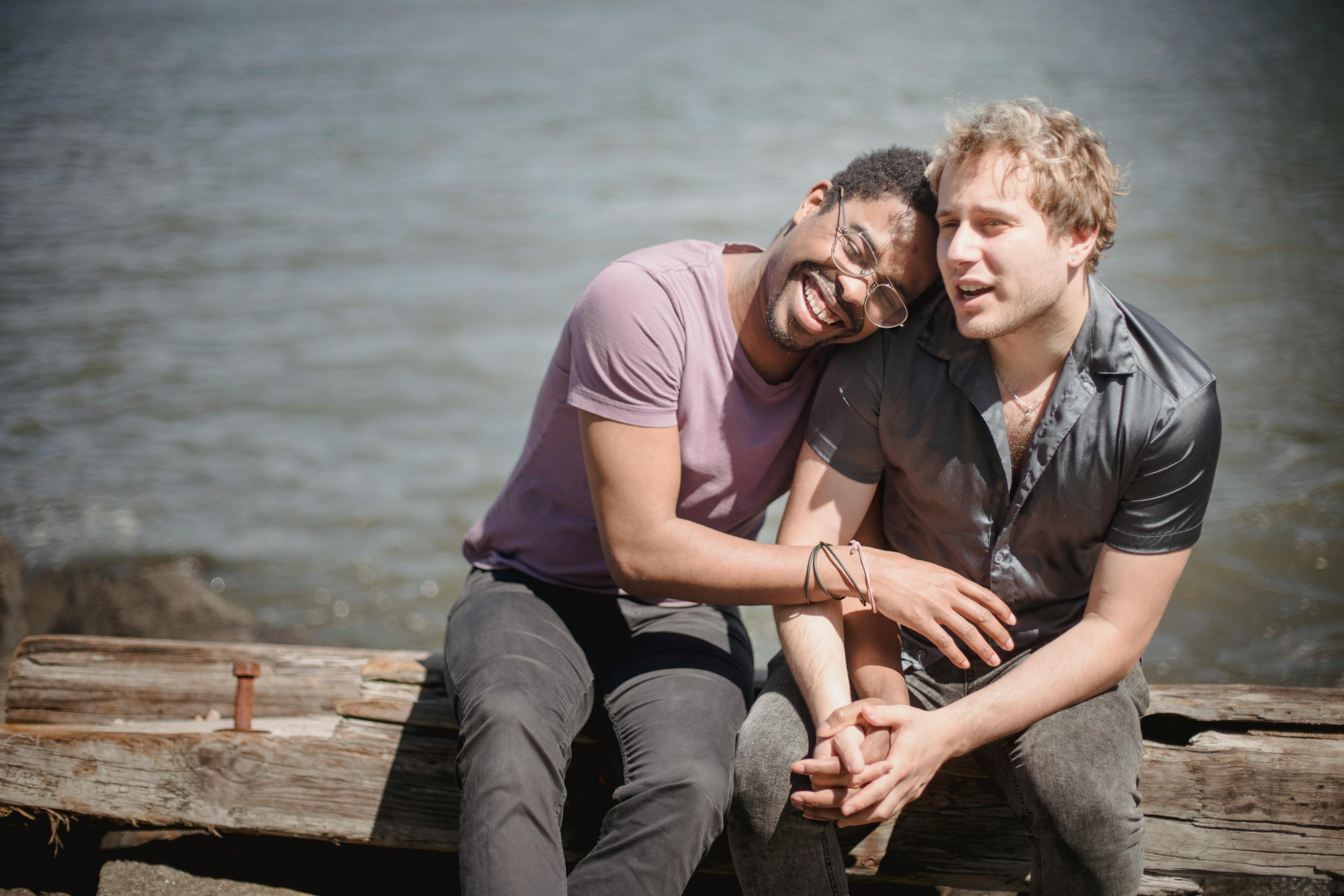 men holding hands and sitting together