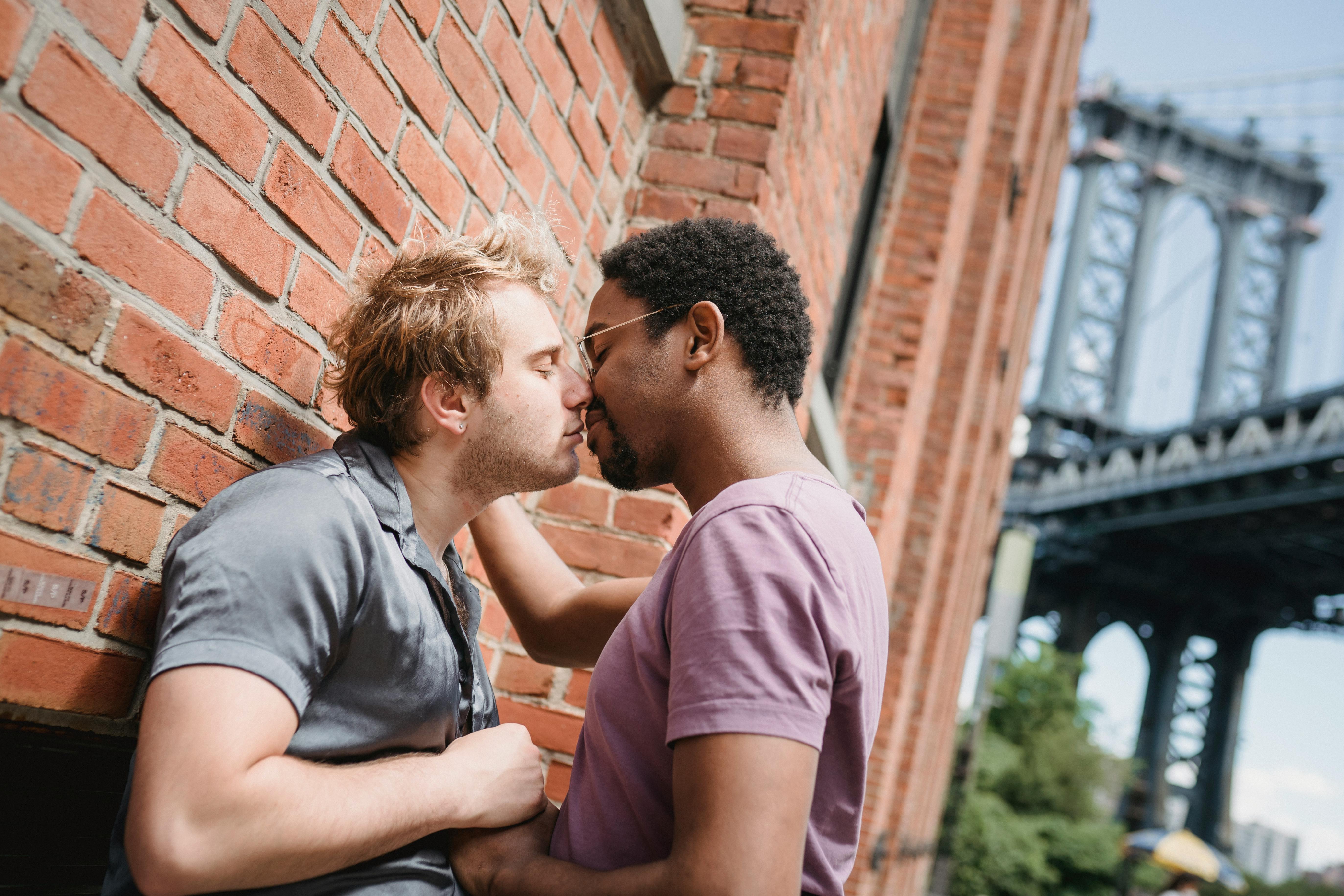 two men kissing outside