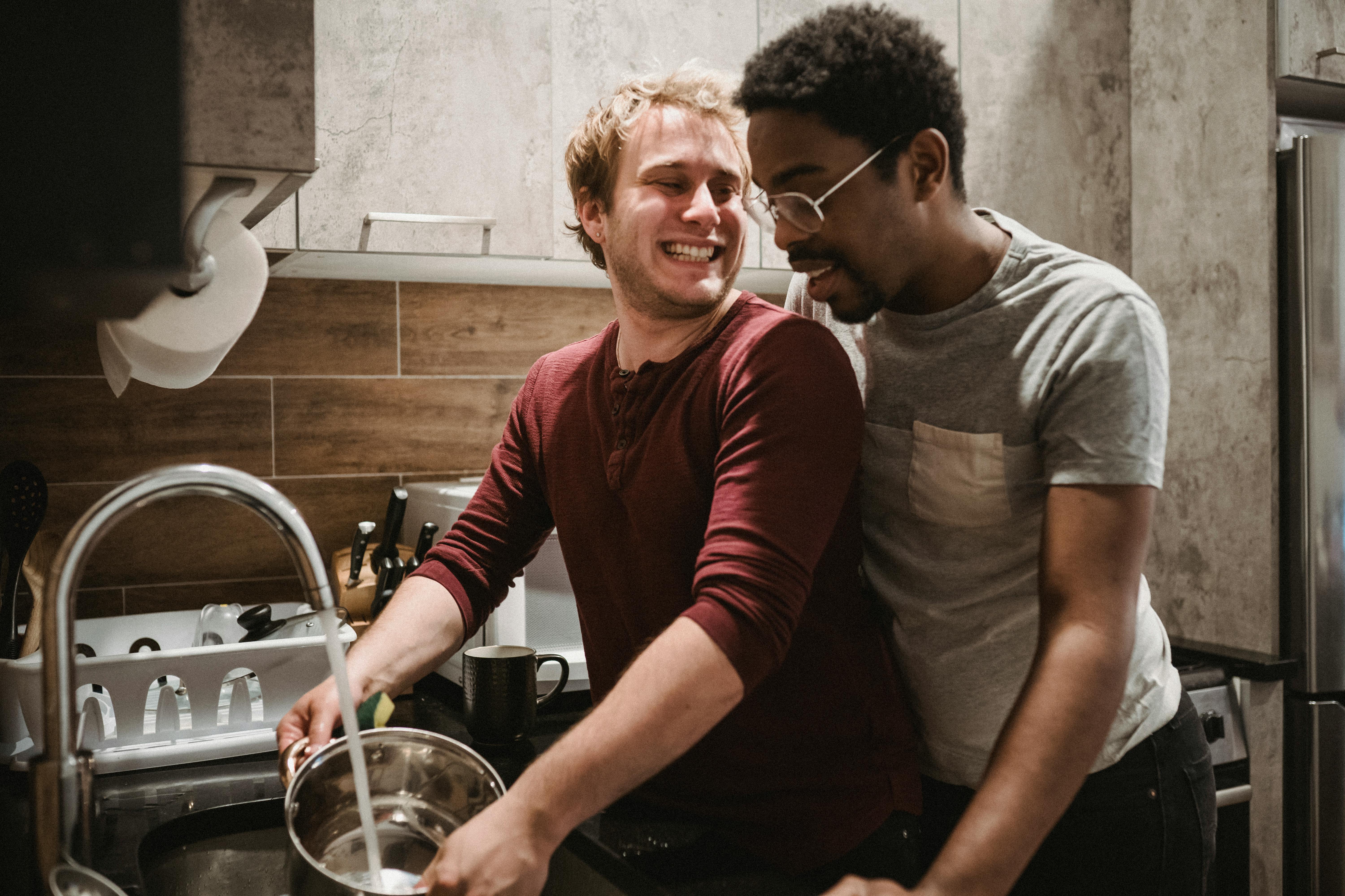 two men smiling in a kitchen