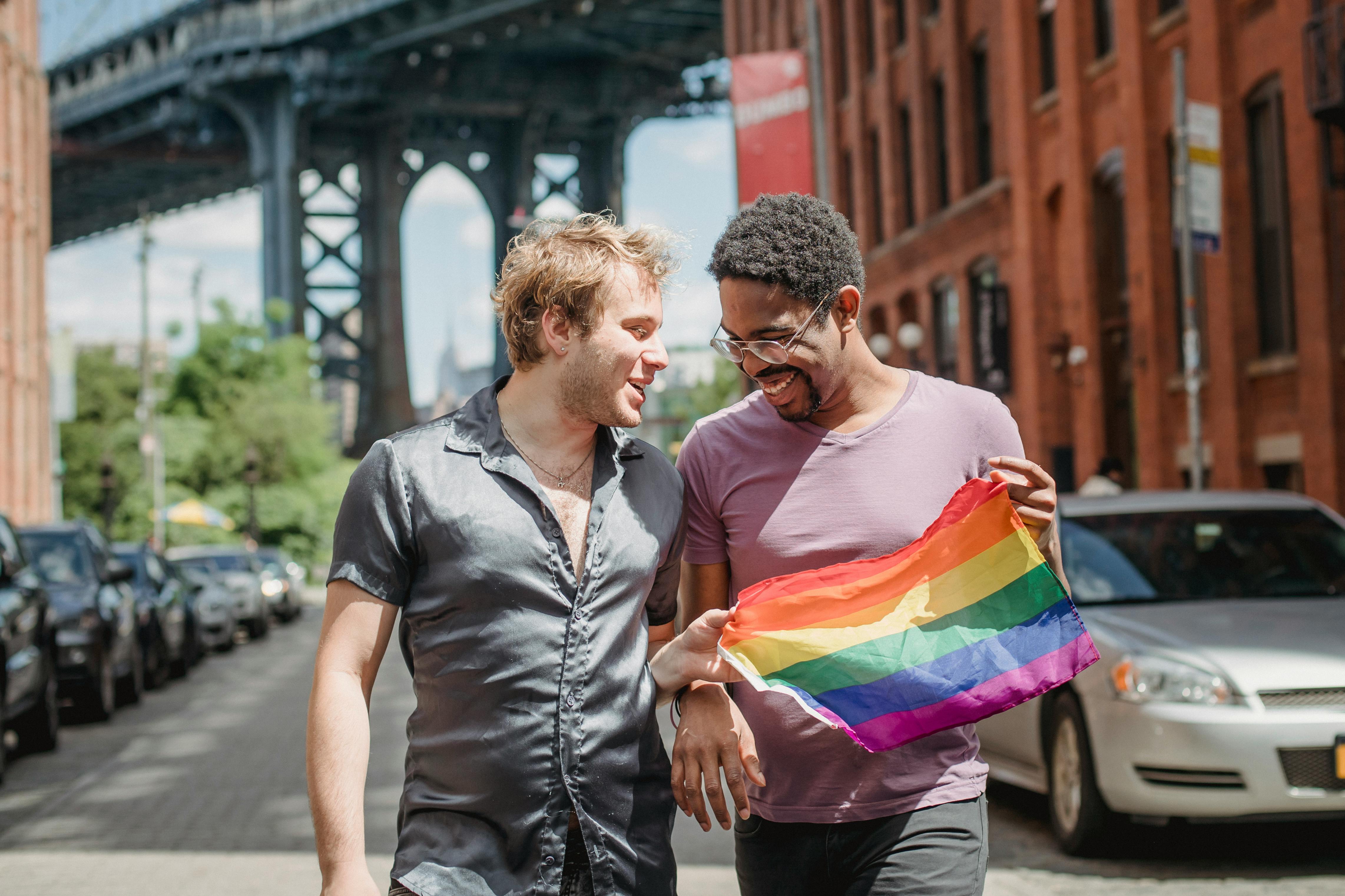 happy couple holding a lgbt flag