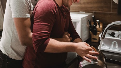 Man Hugging Another Man from Behind